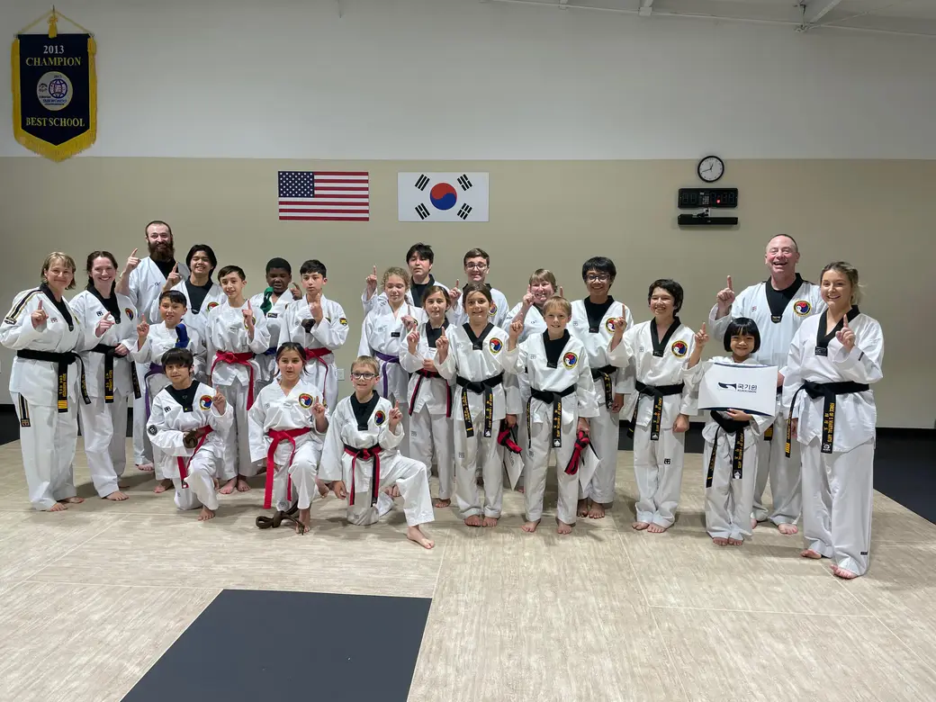 The full Force of One student body of all belt ranks gathered in the dojang
