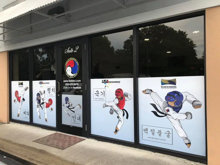 The Force of One Martial Arts storefront, its windows printed with Taekwondo figures and the Korean tenets
